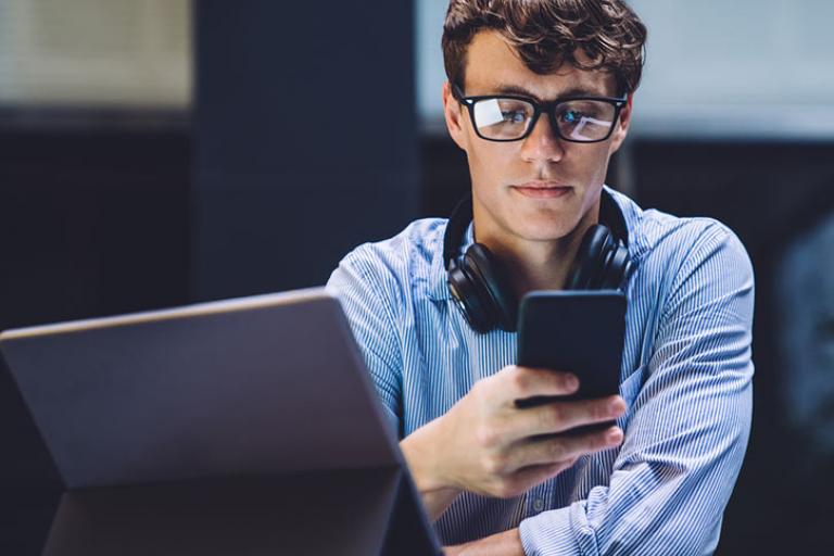 man with laptop and mobile