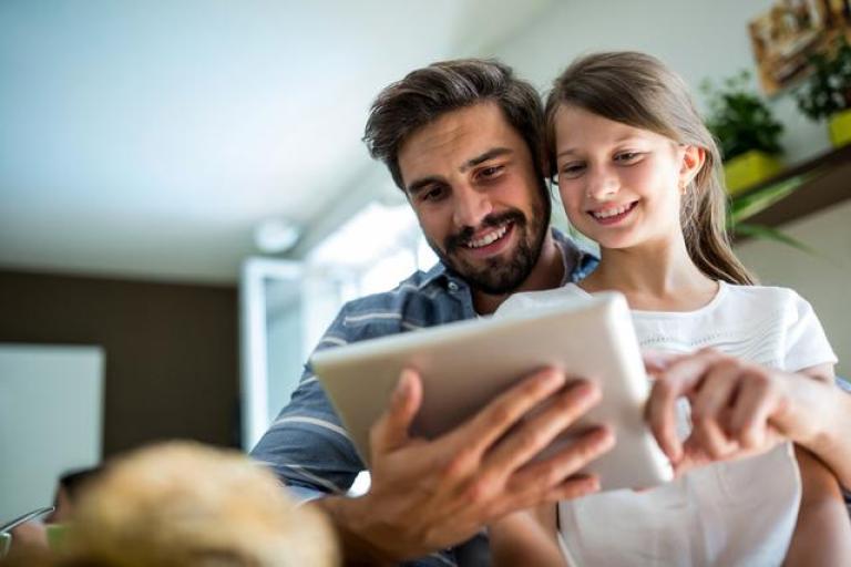 family using tablet for ai