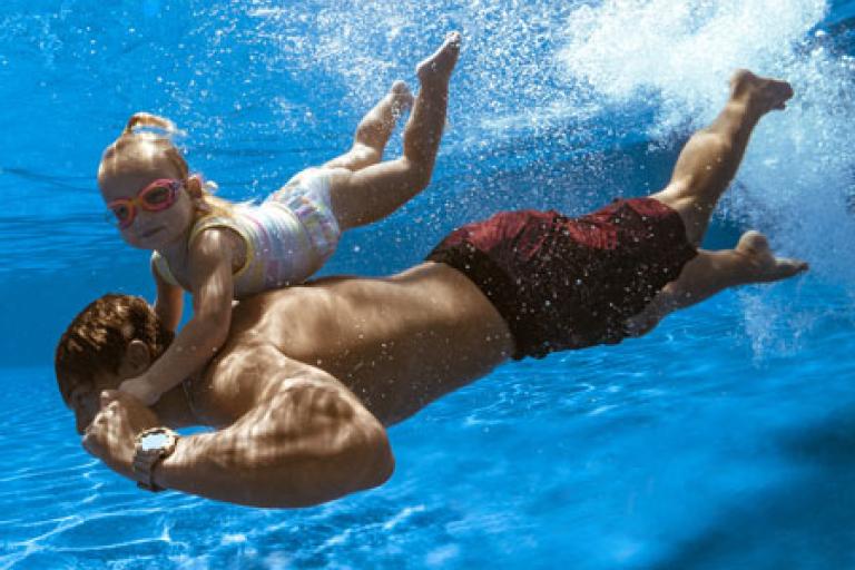 dad and child swimming